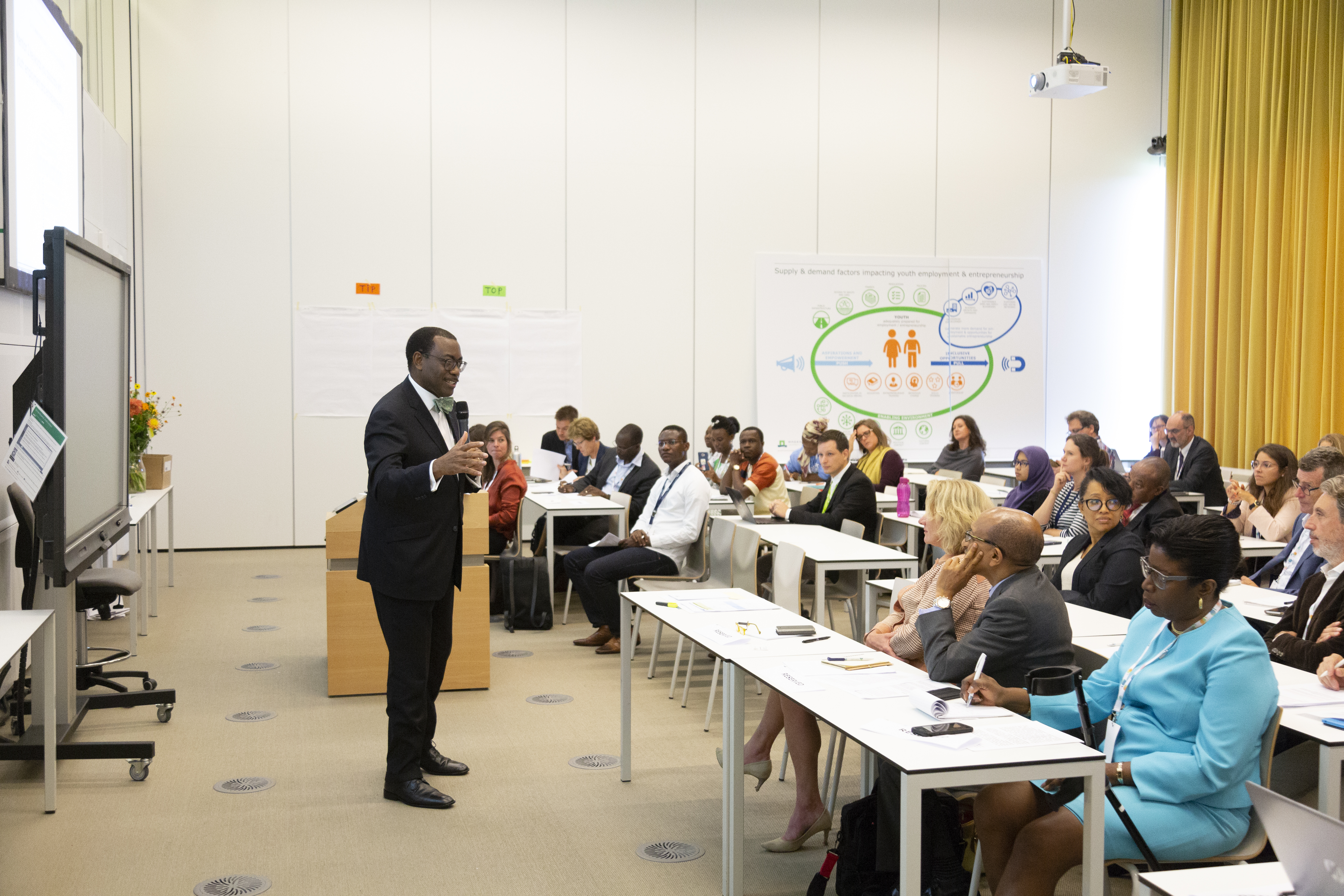 Dr. Adesina presenting to an audience